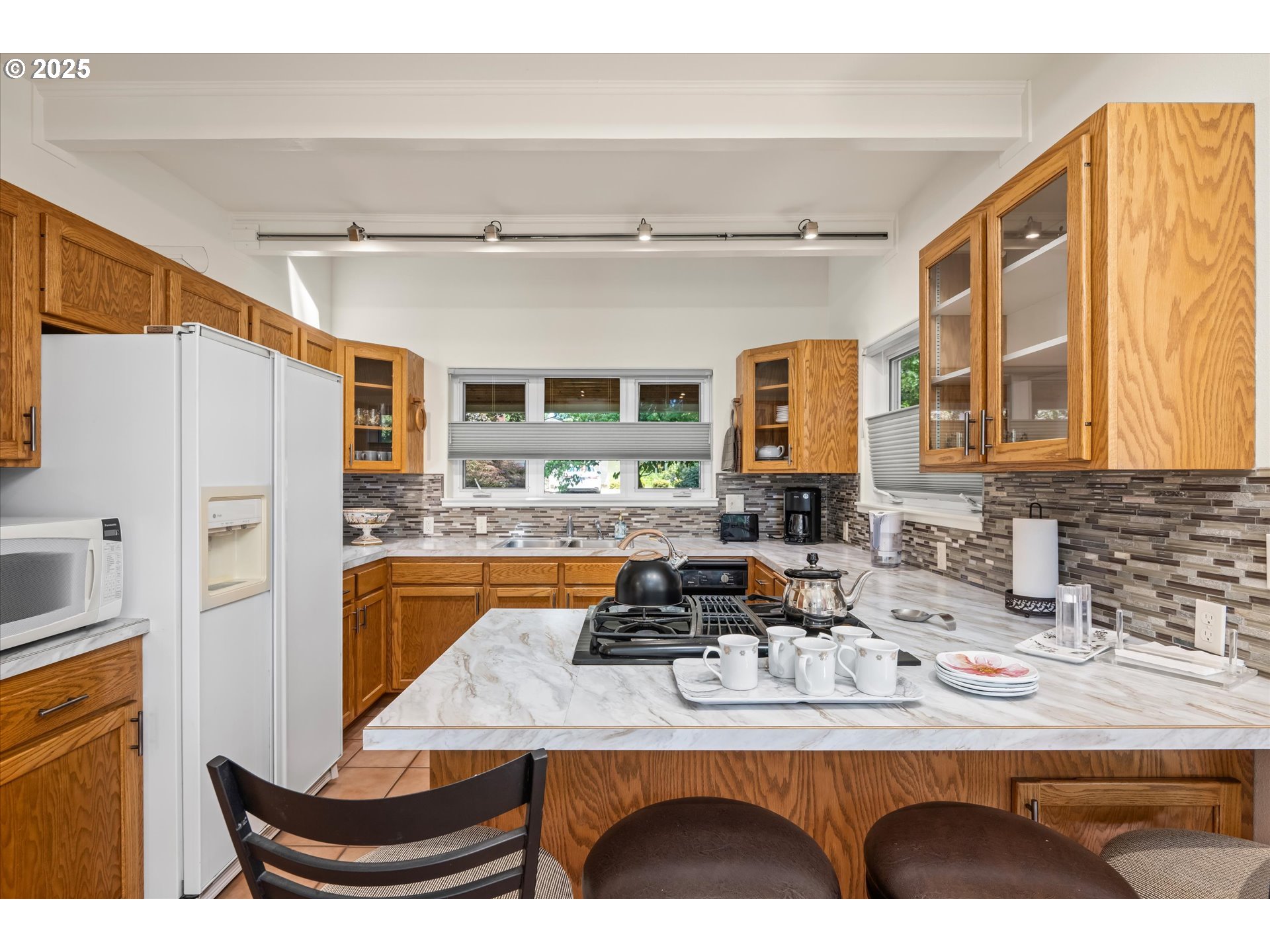 820 Park Terrace Eugene, OR 97404 - Photo 12 of 44 a kitchen with a refrigerator a sink and cabinets