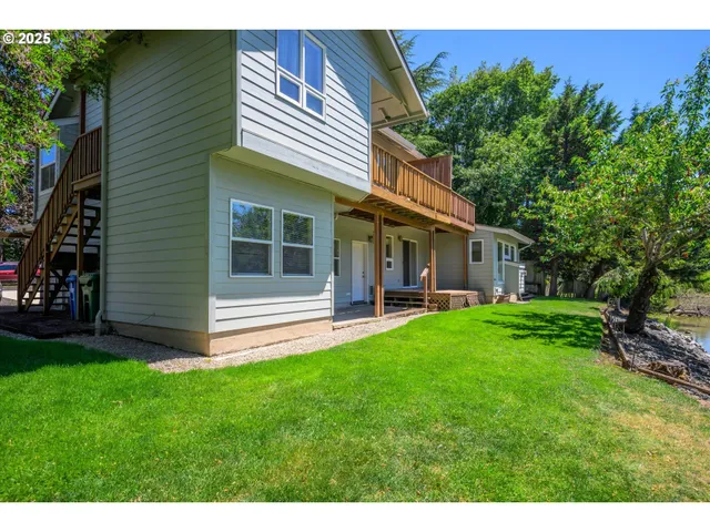 a view of a house with a yard and sitting area