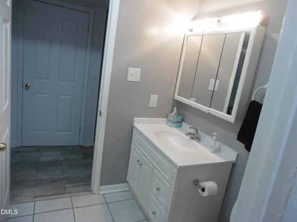a kitchen with granite countertop a refrigerator and a sink