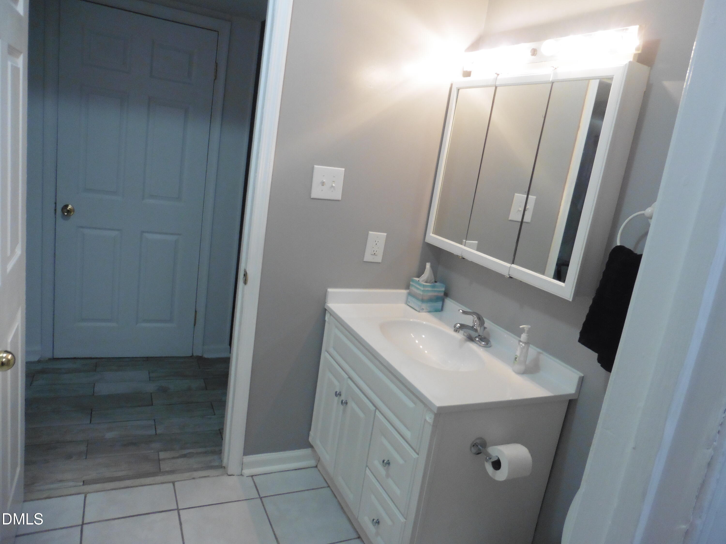 4257 Lake Ridge Drive Raleigh, NC 27604 - Photo 11 of 19 a bathroom with a sink a toilet and a mirror