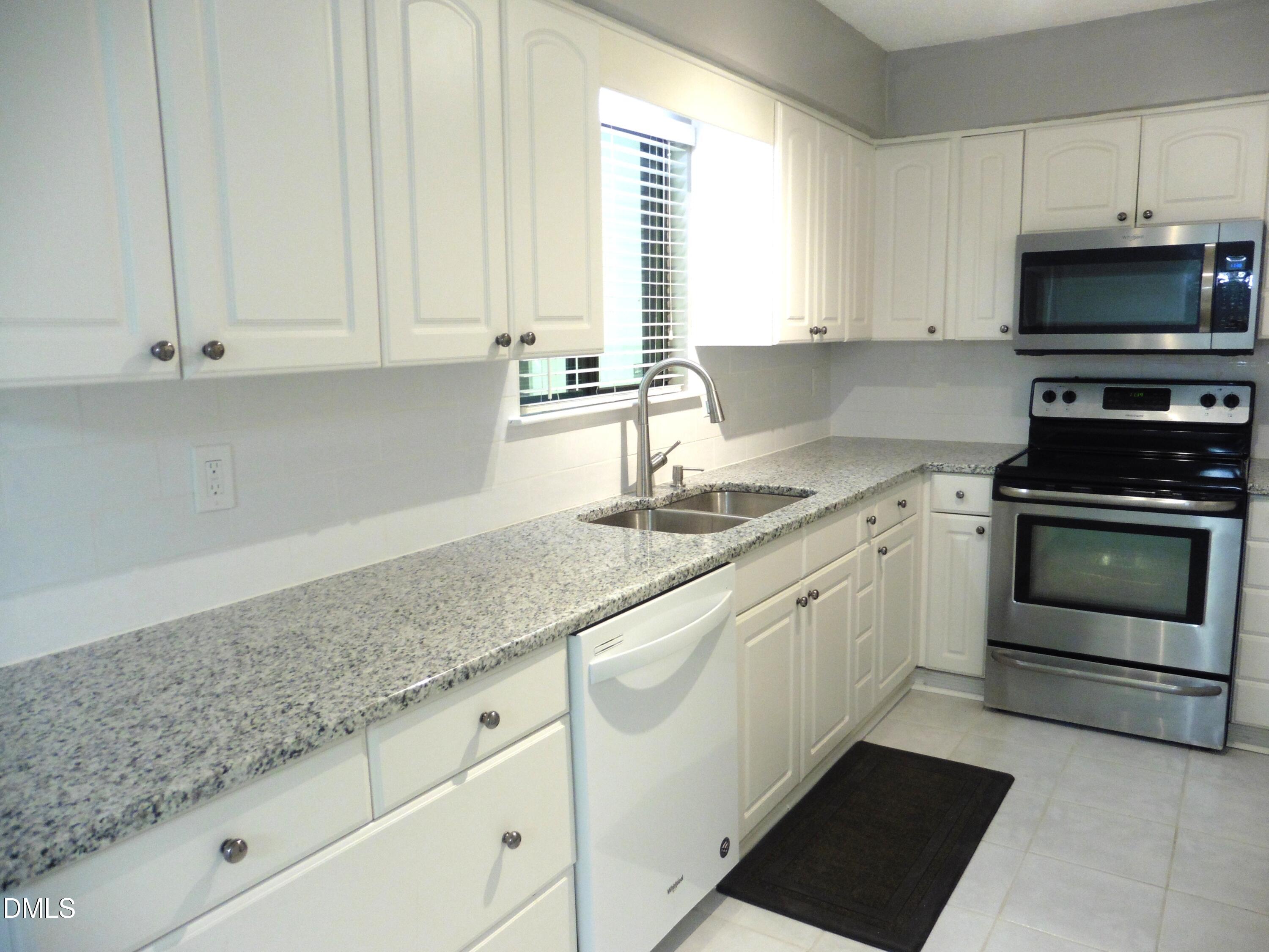 4257 Lake Ridge Drive Raleigh, NC 27604 - Photo 13 of 19 a kitchen with granite countertop a stove sink and microwave