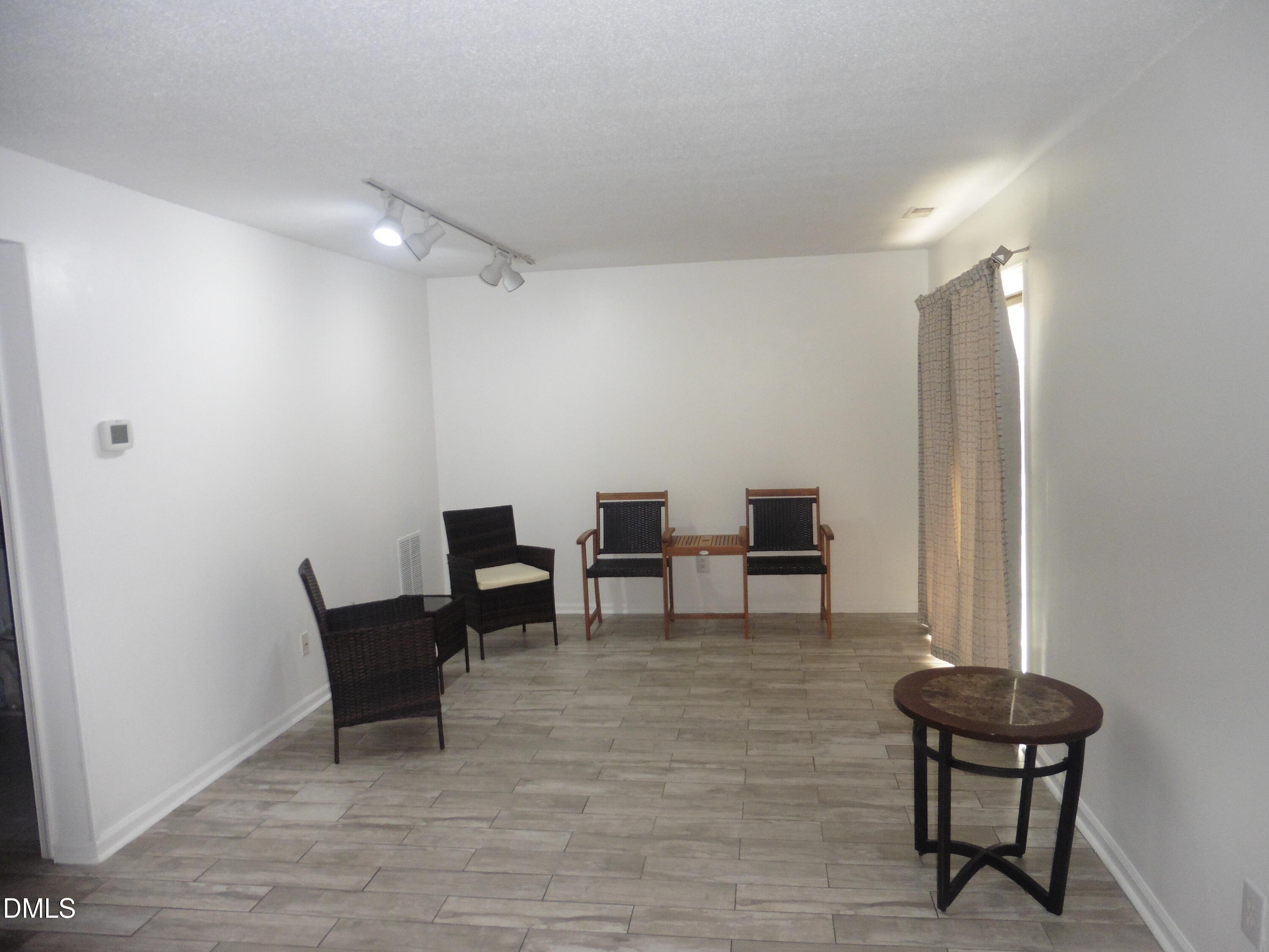 4257 Lake Ridge Drive Raleigh, NC 27604 - Photo 7 of 19 a view of a livingroom with lounge chair and a window