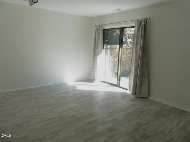 a view of empty room with floor to ceiling window