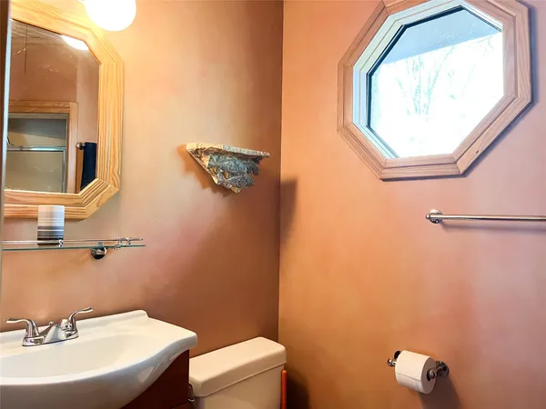 a bathroom with a sink a mirror and a toilet