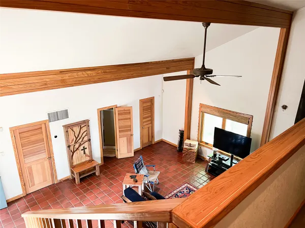 a living room with furniture a flat screen tv and a floor