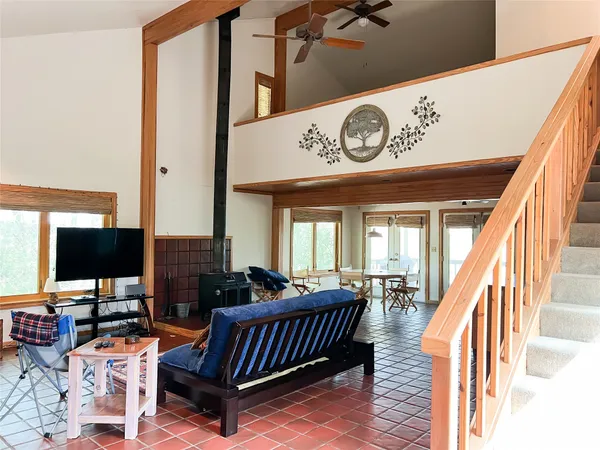 a view of a livingroom with furniture flat screen tv and a floor to ceiling window