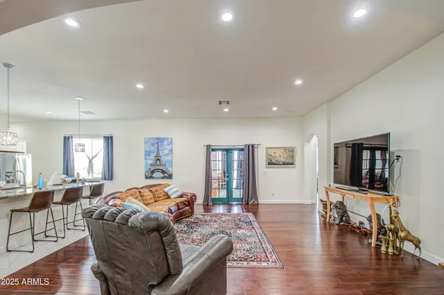 a kitchen with refrigerator and chairs