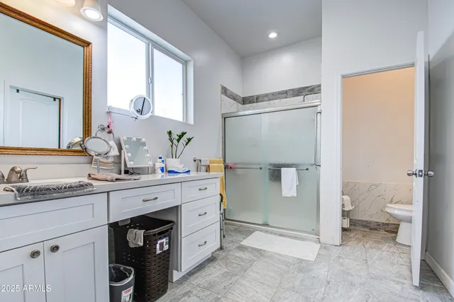 a bathroom with a sink toilet and shower