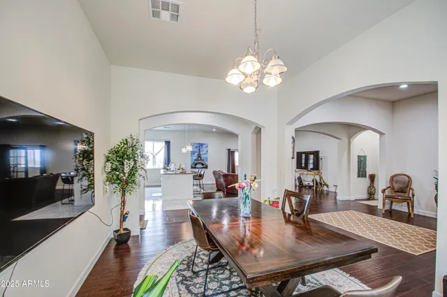 a bedroom with furniture a flat screen tv and a potted plant