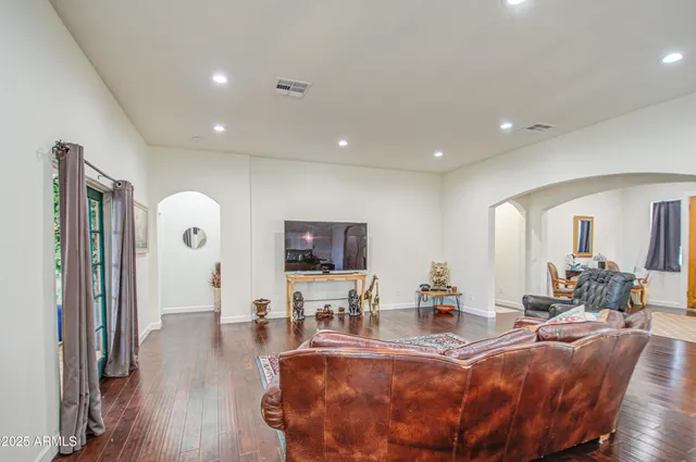 a kitchen with stainless steel appliances kitchen island granite countertop a stove top oven a sink a dining table and chairs