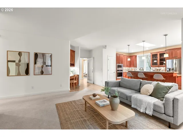 a living room with furniture and kitchen view