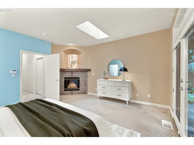 a bedroom with a bed and a fireplace