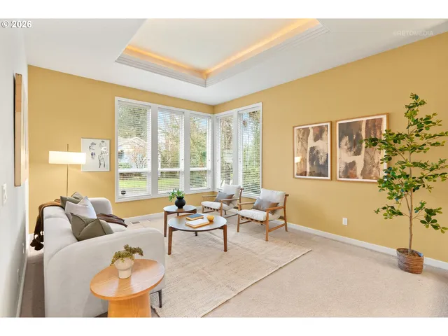 a living room with furniture and a floor to ceiling window