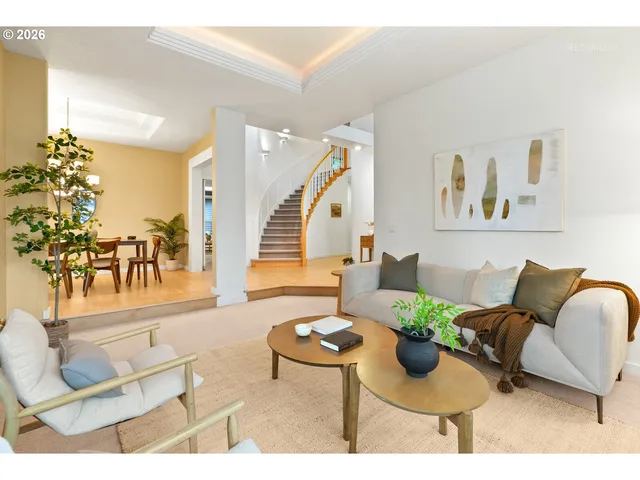 a living room with furniture and a dining table