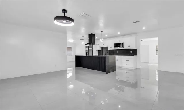 a kitchen with stainless steel appliances granite countertop a sink and stove