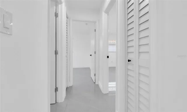 an empty room with a ceiling fan and window