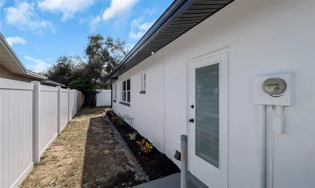 a view of a pathway of a house with wooden wall