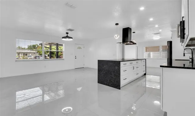 a kitchen with granite countertop a sink and a stove top oven