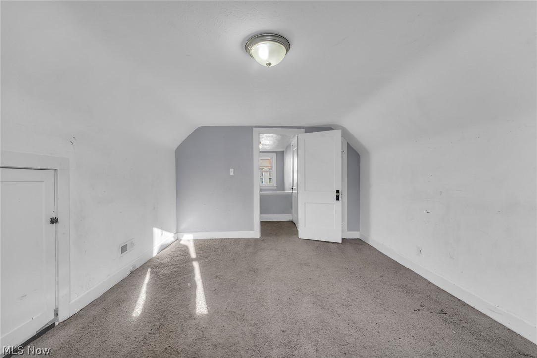 1858 Rudwick Road Cleveland, OH 44112 - Photo 24 of 36 Bonus room featuring lofted ceiling and speckled floor