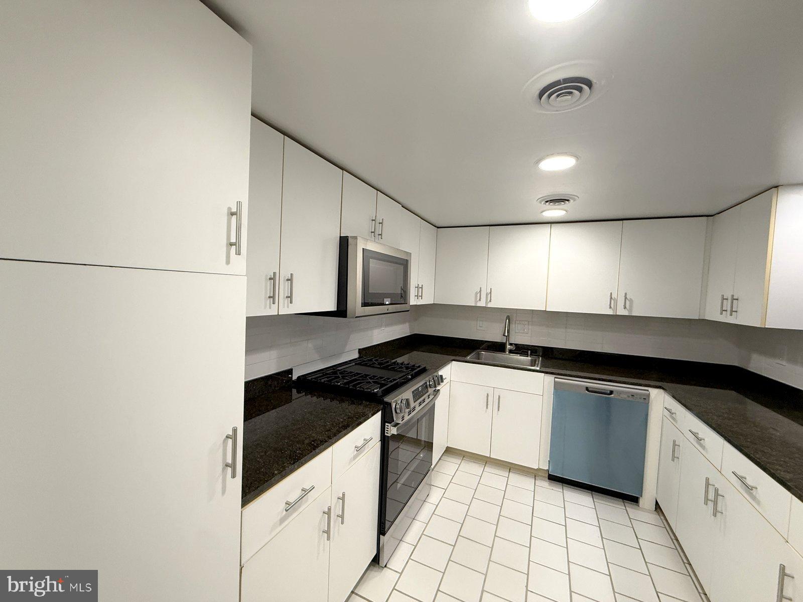 606 Cooper Landing Road, Unit B6A Cherry Hill, NJ 08002 - Photo 3 of 11 a kitchen with granite countertop a sink and a stove top oven