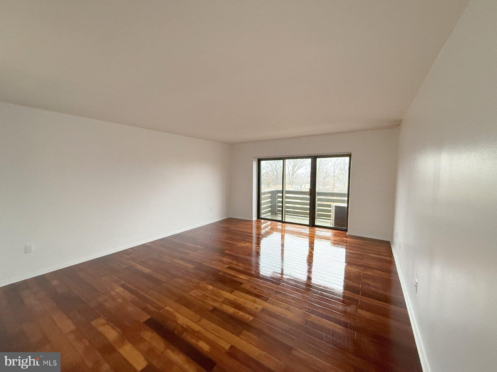 606 Cooper Landing Road, Unit B6A Cherry Hill, NJ 08002 - Photo 6 of 11 wooden floor in an empty room with a window
