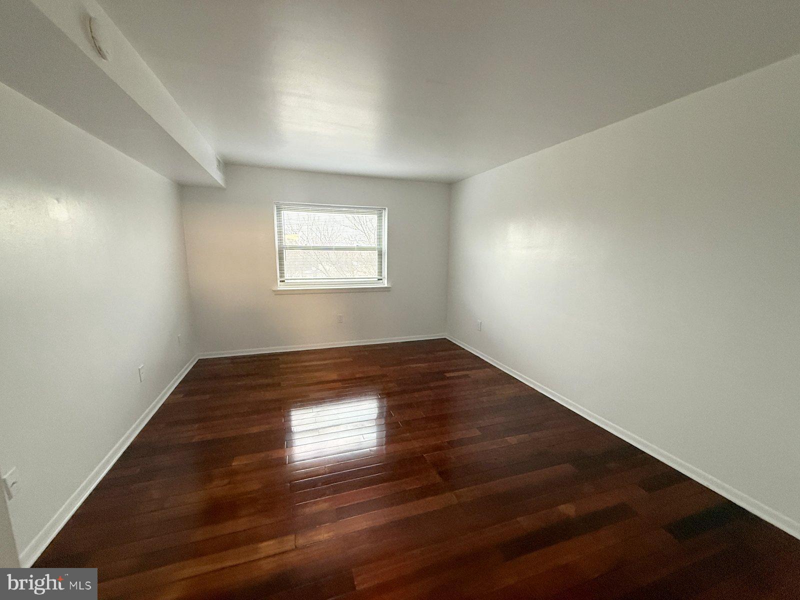 606 Cooper Landing Road, Unit B6A Cherry Hill, NJ 08002 - Photo 8 of 11 an empty room with wooden floor and windows