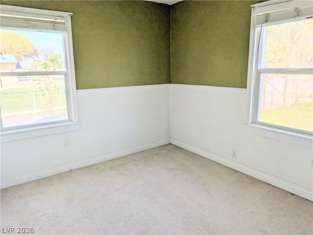 1 South 5th Street Panaca, NV 89042 - Photo 14 of 21 Third bedroom featuring plenty of natural light and light colored carpet