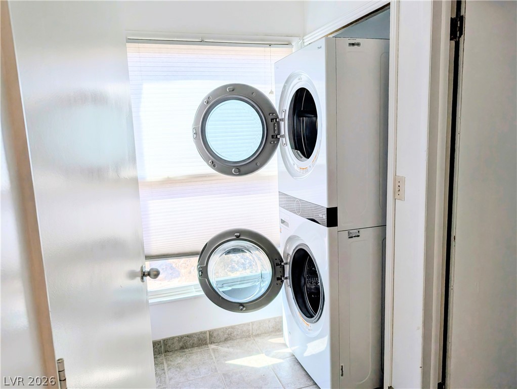 1 South 5th Street Panaca, NV 89042 - Photo 19 of 21 Laundry area featuring stacked washer and clothes dryer and light tile patterned floors