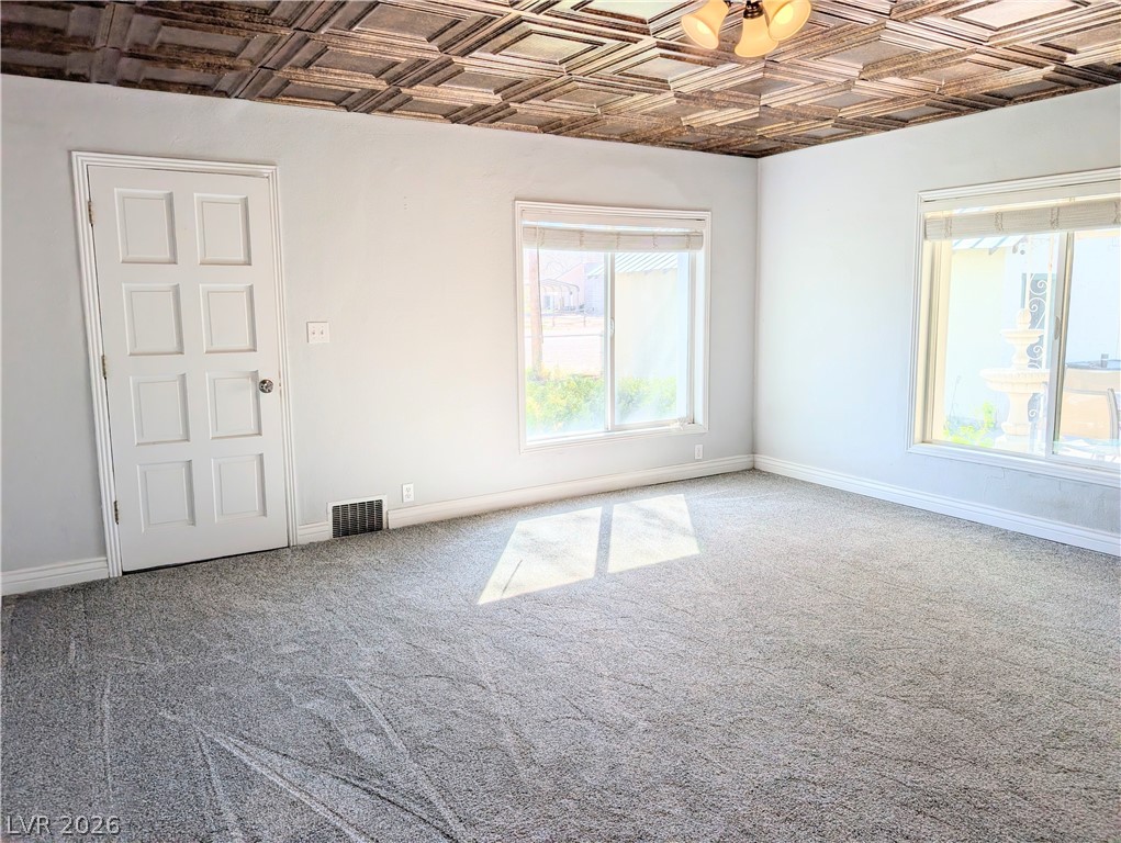1 South 5th Street Panaca, NV 89042 - Photo 5 of 21 Living room featuring an ornate ceiling and carpet flooring