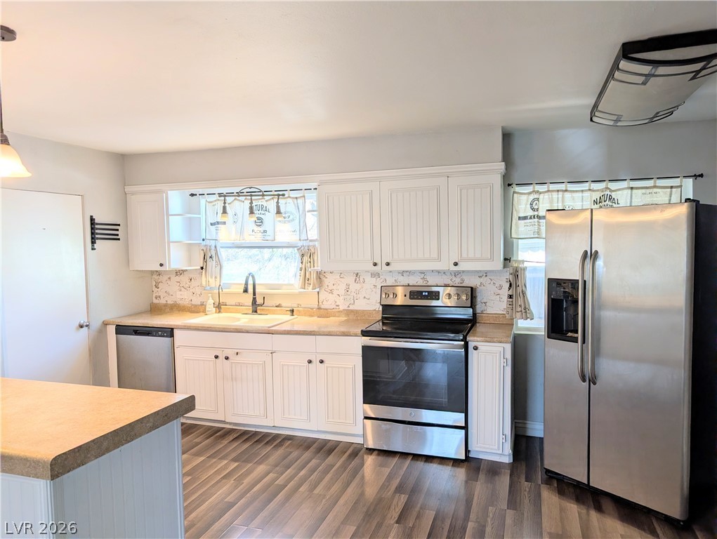 1 South 5th Street Panaca, NV 89042 - Photo 6 of 21 Kitchen with stainless steel appliances, white cabinets, and dark wood-style flooring