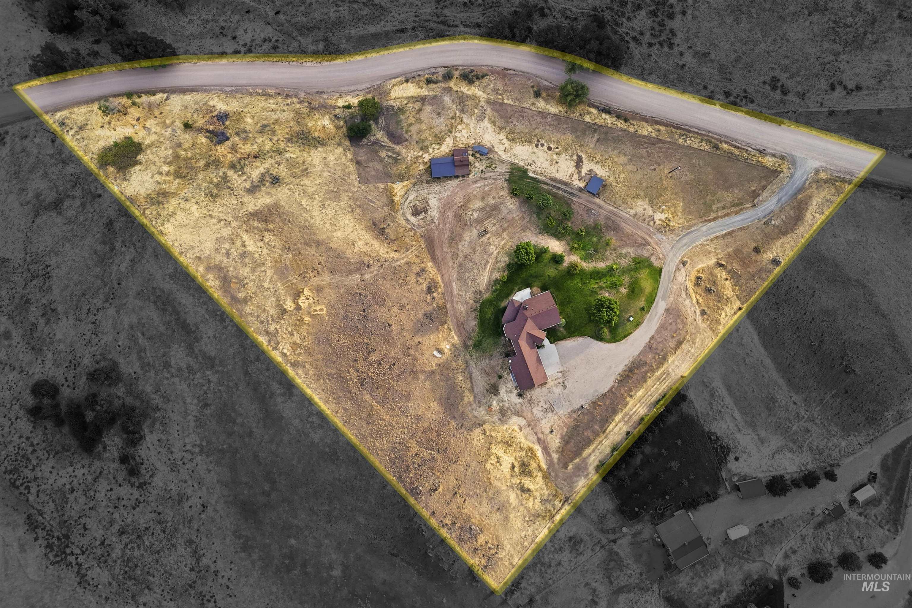 3645 Butte Road Emmett, ID 83617 - Photo 34 of 39 Expansive property featuring a residence with a brown roof, an established driveway, and surrounding varied terrain