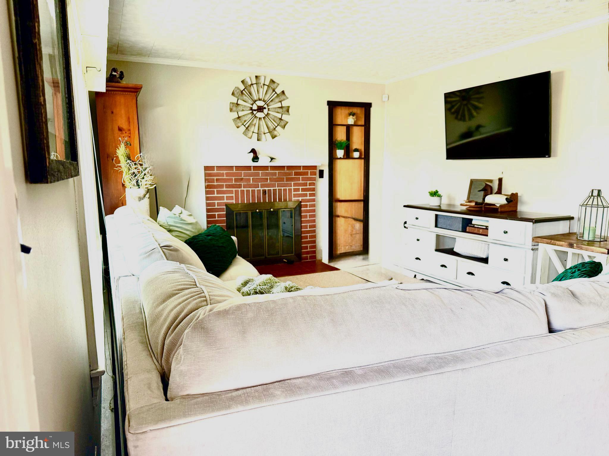 202 4th Street Sharptown, MD 21861 - Photo 15 of 73 a bedroom with a bed and flat screen tv