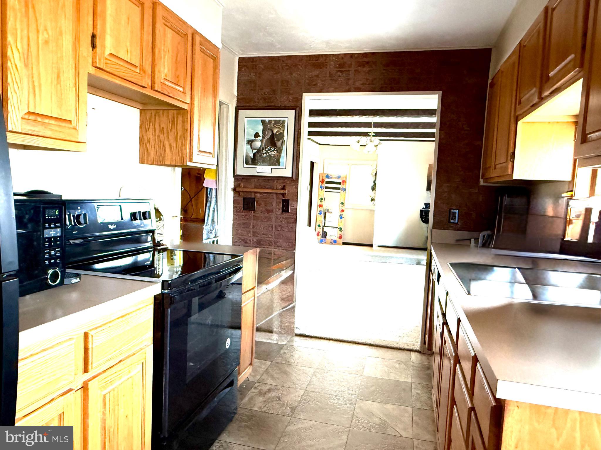202 4th Street Sharptown, MD 21861 - Photo 24 of 73 a kitchen with stainless steel appliances granite countertop a sink stove and a refrigerator