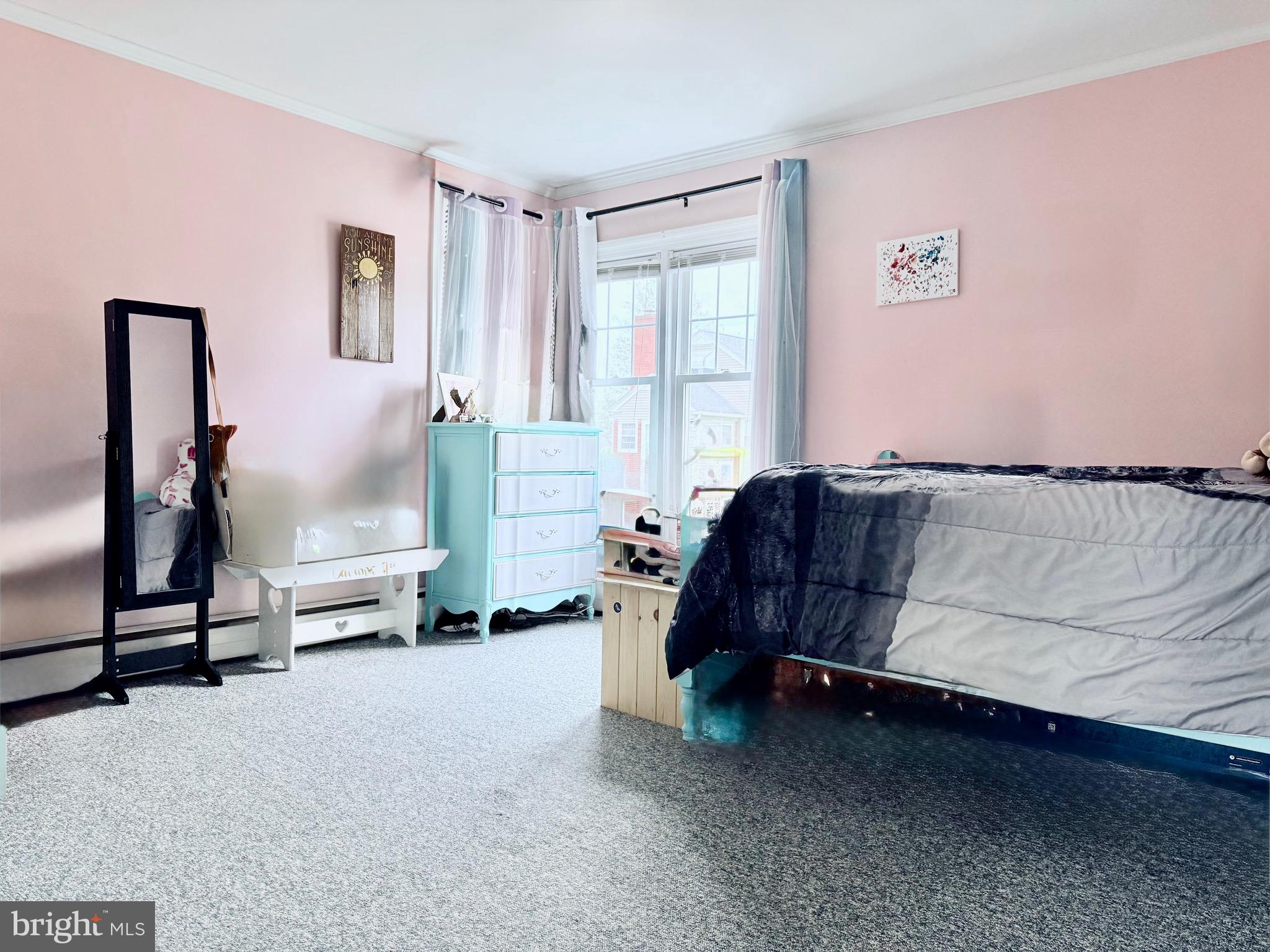 202 4th Street Sharptown, MD 21861 - Photo 55 of 73 a bedroom with a bed and a chandelier