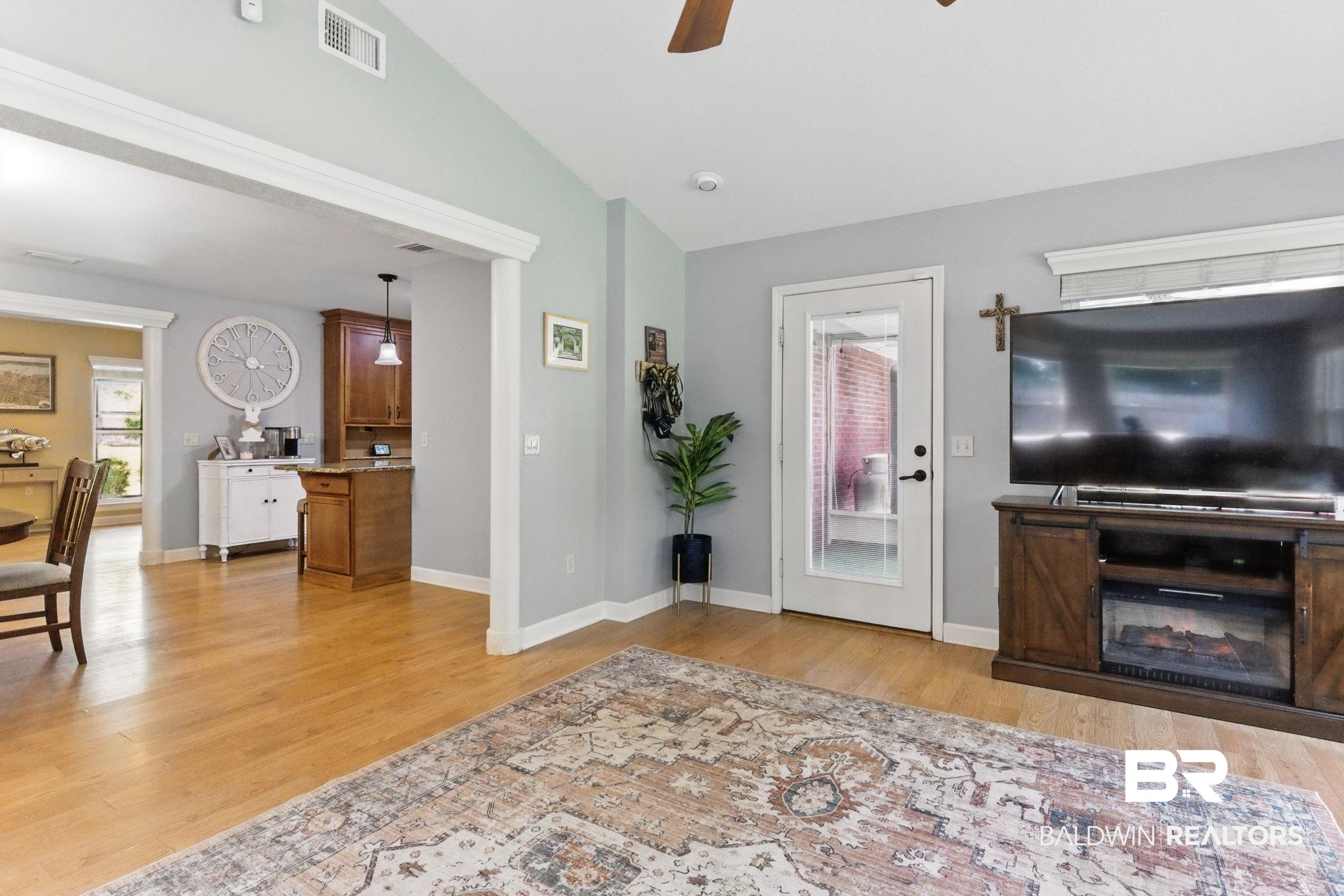 32345 River Lake Road Seminole, AL 36574 - Photo 6 of 56 Living room featuring ceiling fan, light wood-style flooring, visible vents, lofted ceiling, and baseboards