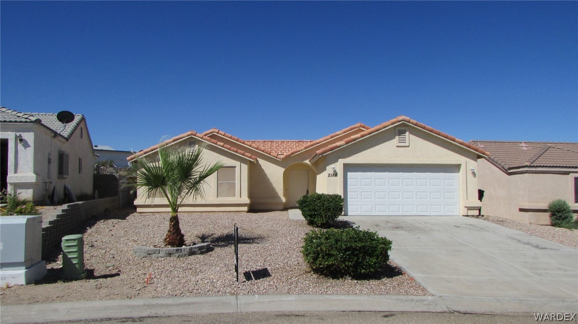 2188 Jamie Road Fort Mohave, AZ 86426 - Photo 1 of 21 a front view of a house with a yard