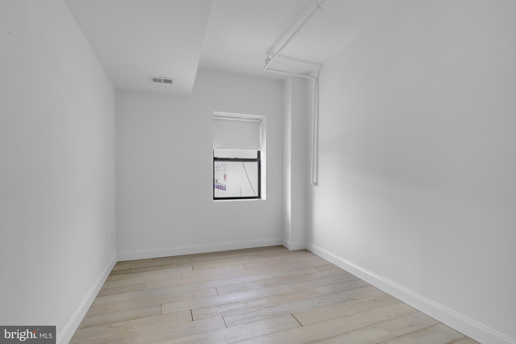 301 Spring Garden Street, Unit 3B Philadelphia, PA 19123 - Photo 11 of 22 an empty room with a window