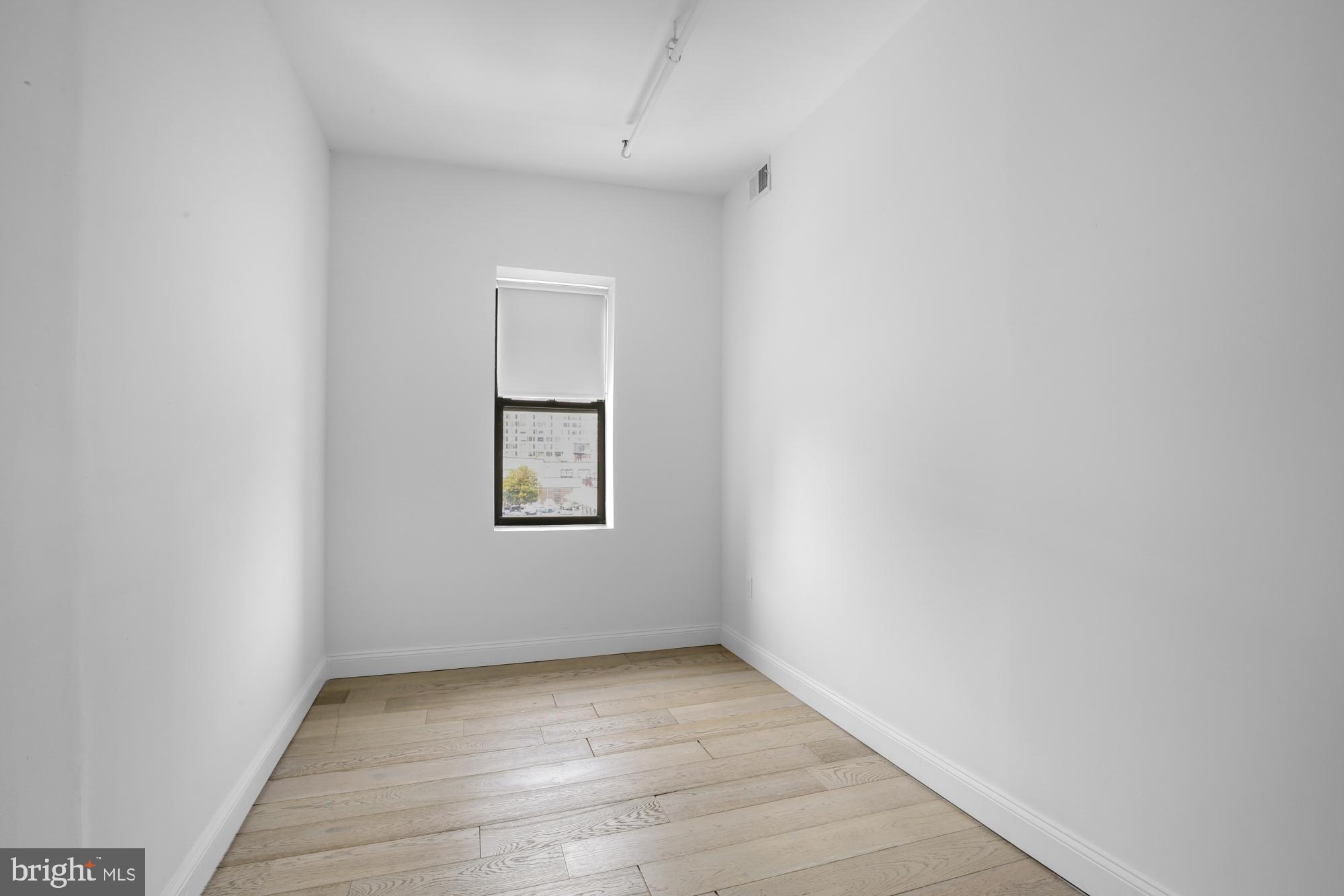 301 Spring Garden Street, Unit 3B Philadelphia, PA 19123 - Photo 14 of 22 an empty room with a window