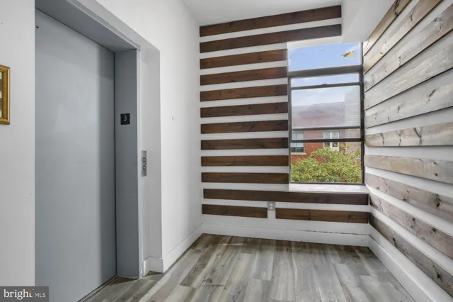 a view of a room with wooden floor and window