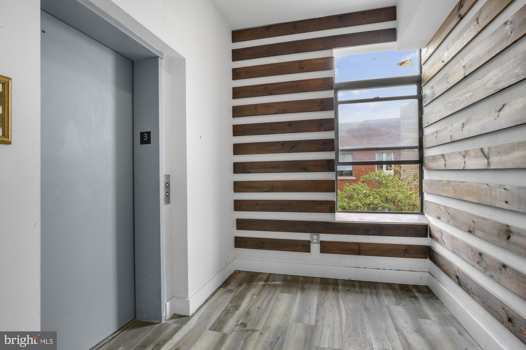 301 Spring Garden Street, Unit 3B Philadelphia, PA 19123 - Photo 19 of 22 a view of a room with wooden floor and window