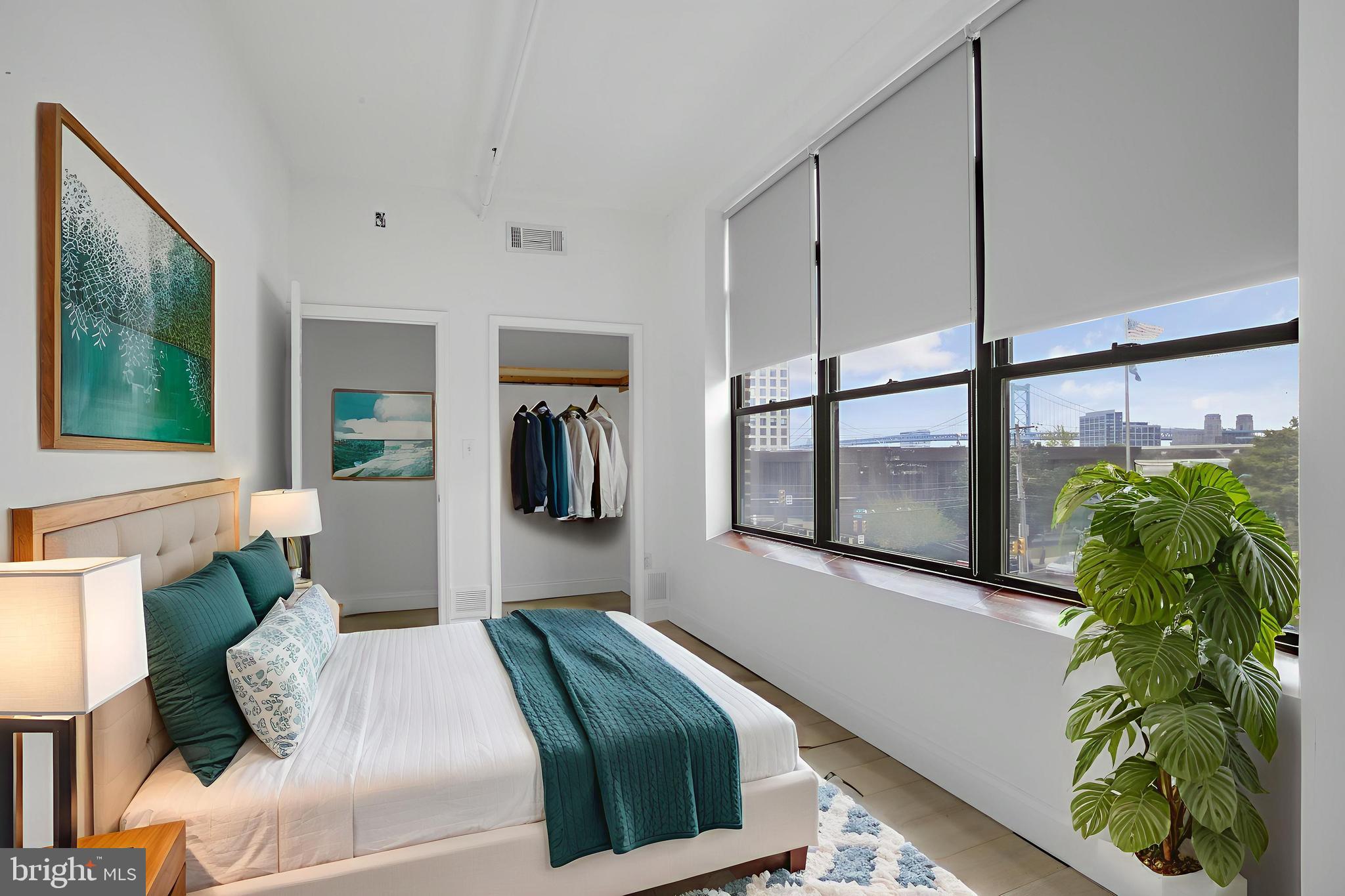301 Spring Garden Street, Unit 3B Philadelphia, PA 19123 - Photo 2 of 22 a bedroom with bed and a potted plant