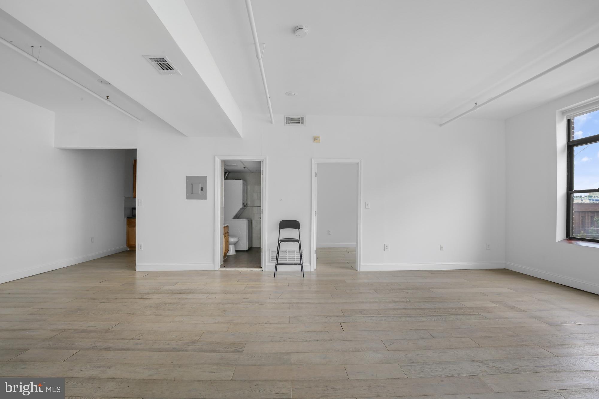 301 Spring Garden Street, Unit 3B Philadelphia, PA 19123 - Photo 6 of 22 a view of empty room with window and wooden floor