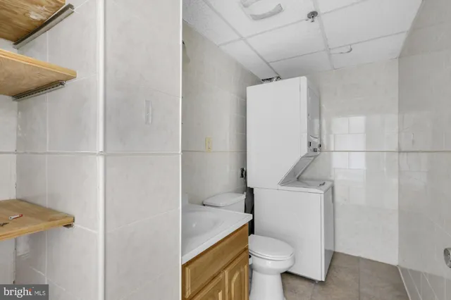a white toilet sitting next to a shower