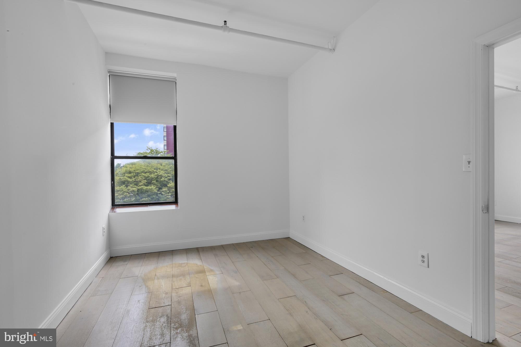 301 Spring Garden Street, Unit 3B Philadelphia, PA 19123 - Photo 9 of 22 an empty room with a window