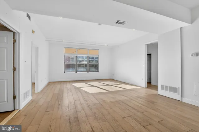 a kitchen with stainless steel appliances granite countertop a refrigerator a sink a stove and white cabinets