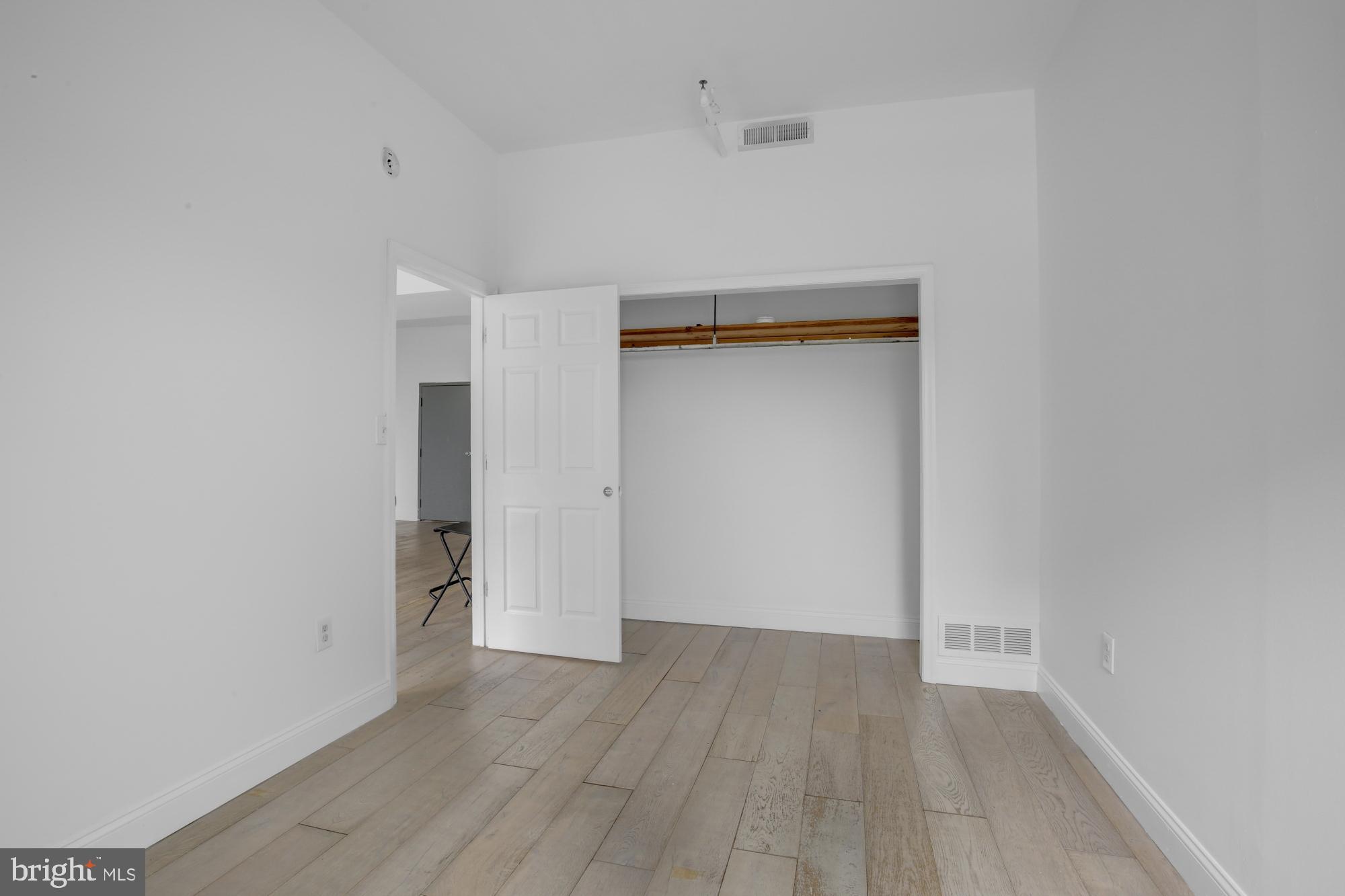 301 Spring Garden Street, Unit 3B Philadelphia, PA 19123 - Photo 10 of 22 a view of an empty room with wooden floor