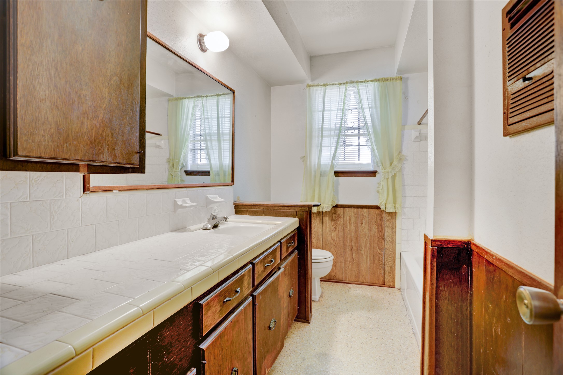 4422 Trigg Street Houston, TX 77093 - Photo 13 of 17 a bathroom with a granite countertop sink and a bathtub