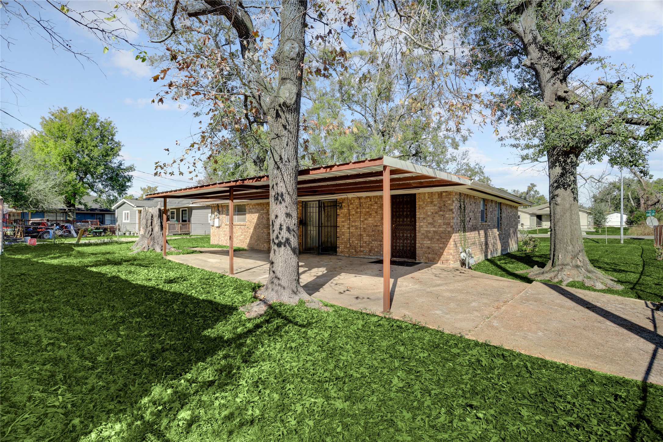 4422 Trigg Street Houston, TX 77093 - Photo 17 of 17 a white house with a small yard and large trees