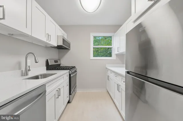 a kitchen with white cabinets and a sink