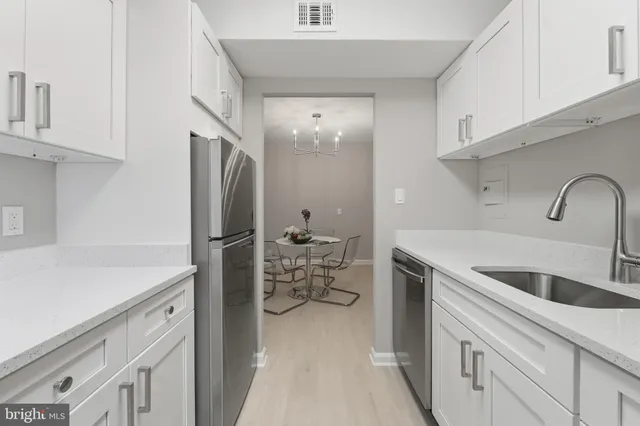 a kitchen with a sink and a refrigerator